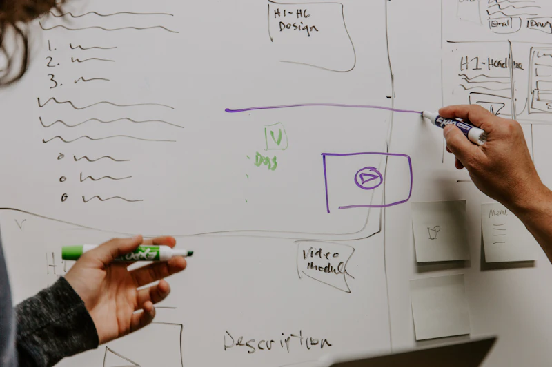 Engineers mapping an architecture on a whiteboard